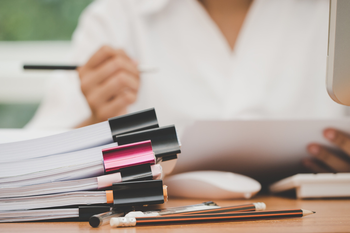 Business professional managing a manual reporting process