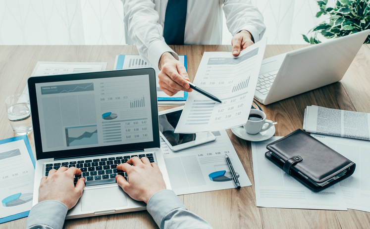 Business consultant and executive reviewing financial reporting
